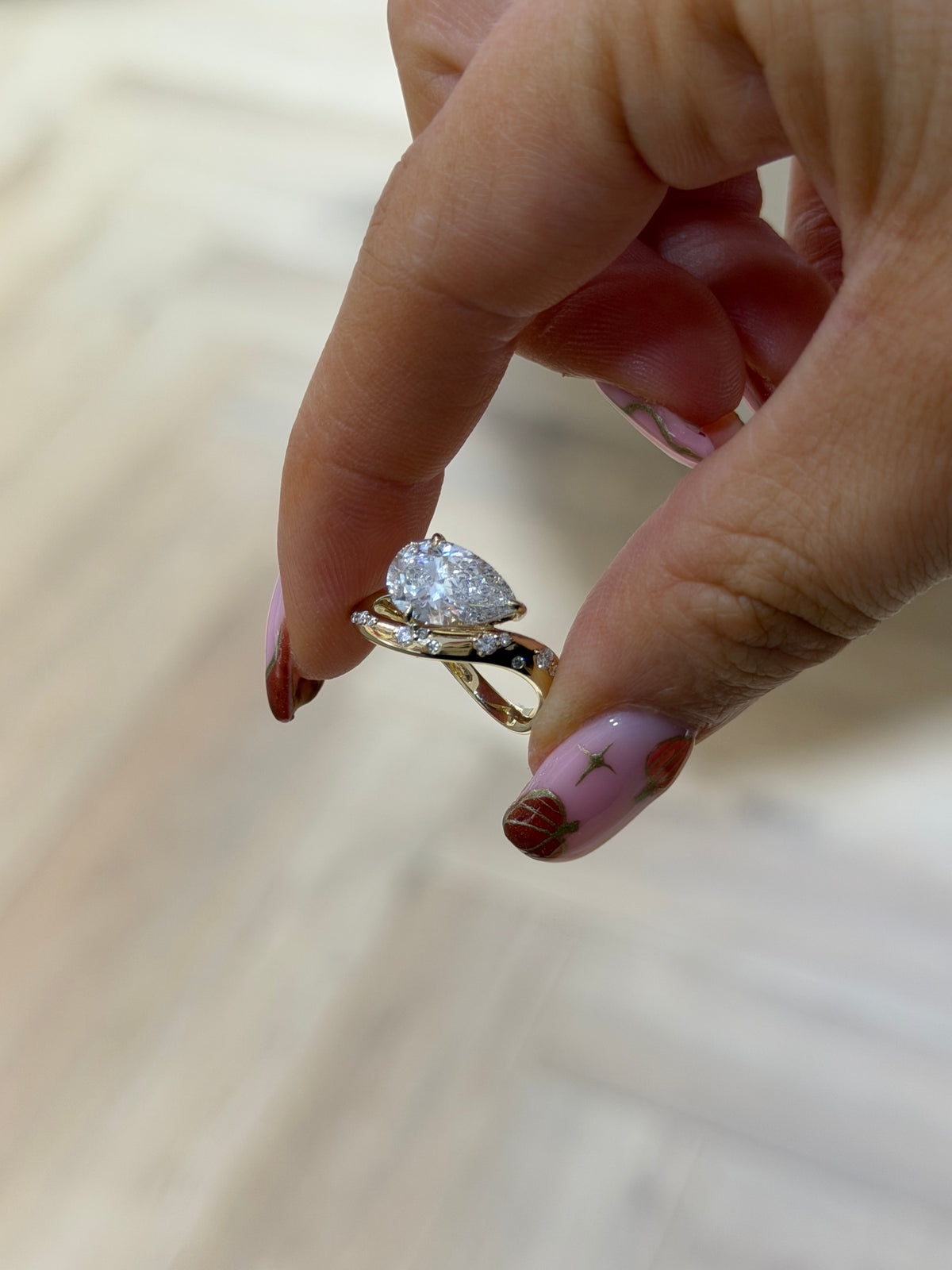 The Orbit pear cut lab diamond bypass ring with flush-set stones, 9k yellow gold