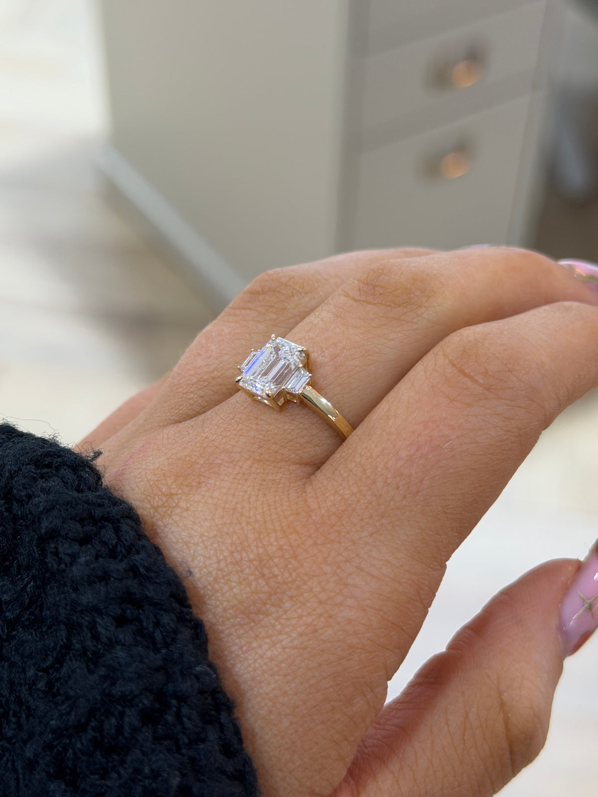 The Margot 2ct emerald cut lab diamond ring in 9k yellow gold, side view on the hand