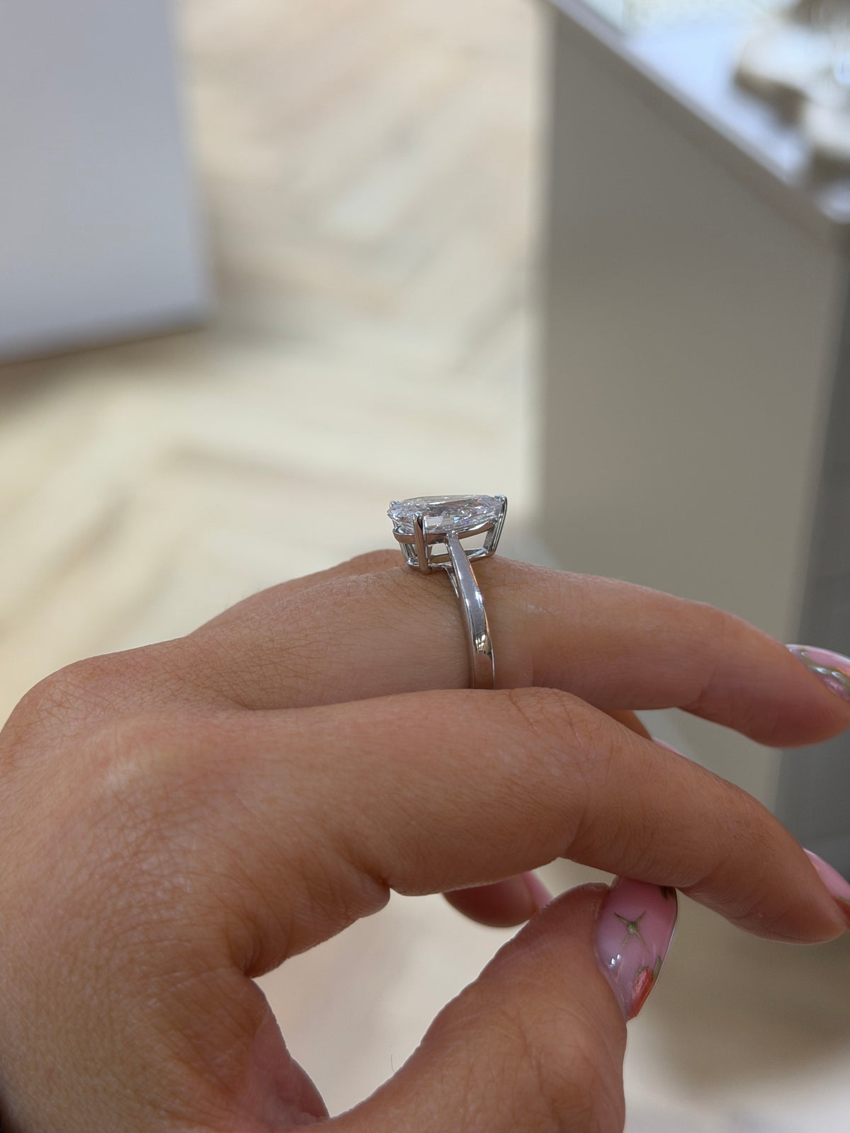 The Adeline pear lab diamond engagement ring in 9k white gold, side view on the hand