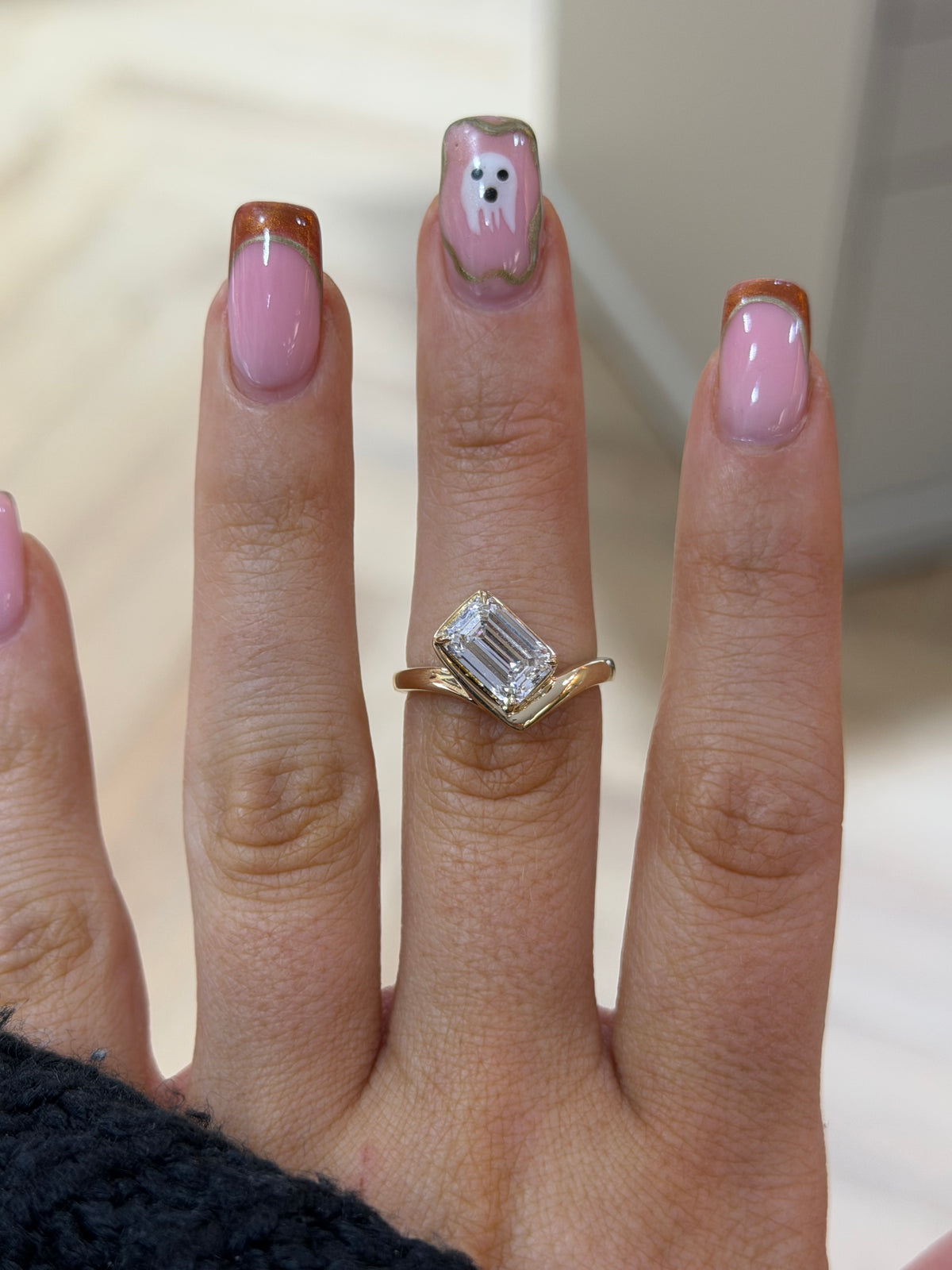 The Élan diagonal emerald cut lab diamond engagement ring, worn on the hand