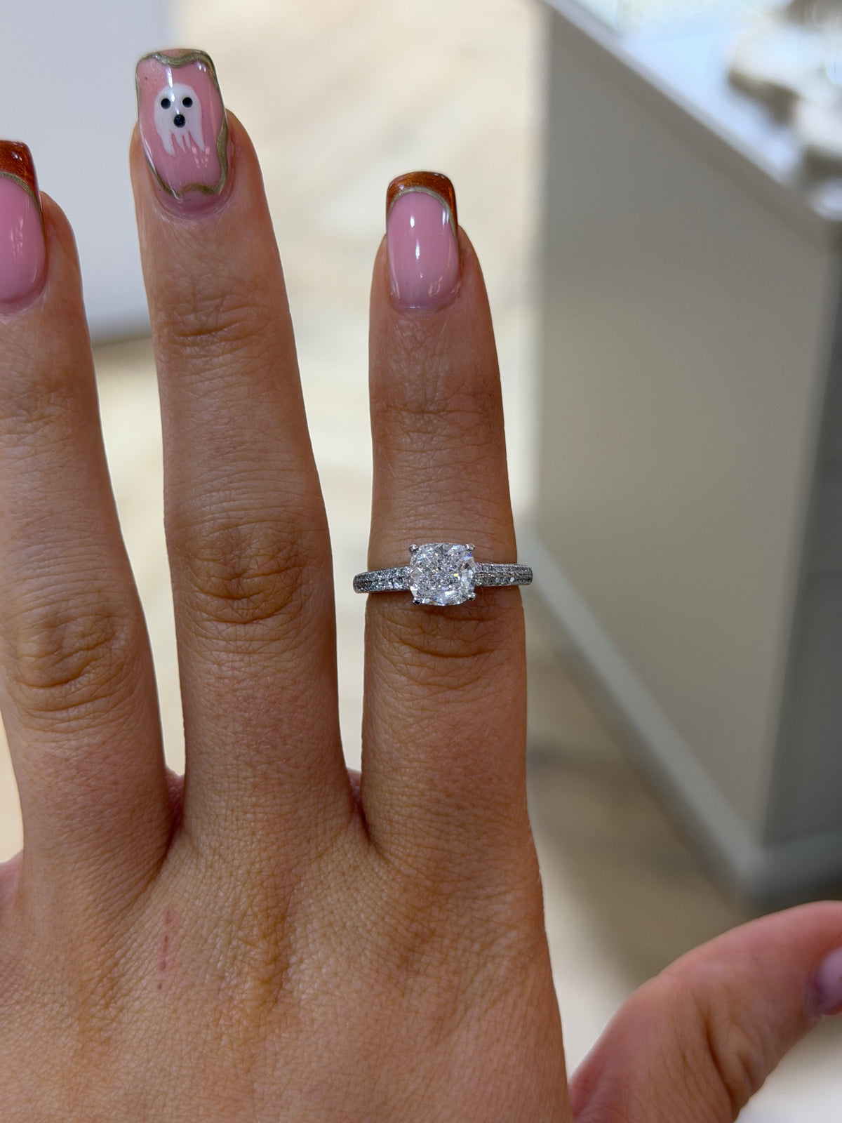 The Camille cushion cut lab diamond pave ring, worn on the hand