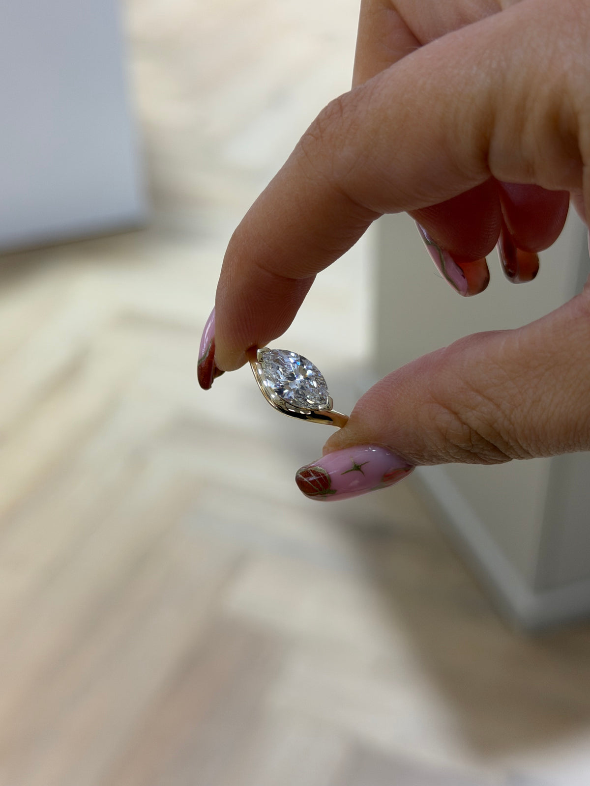 The Solstice east-west marquise diamond ring with sculptural 9k yellow gold band