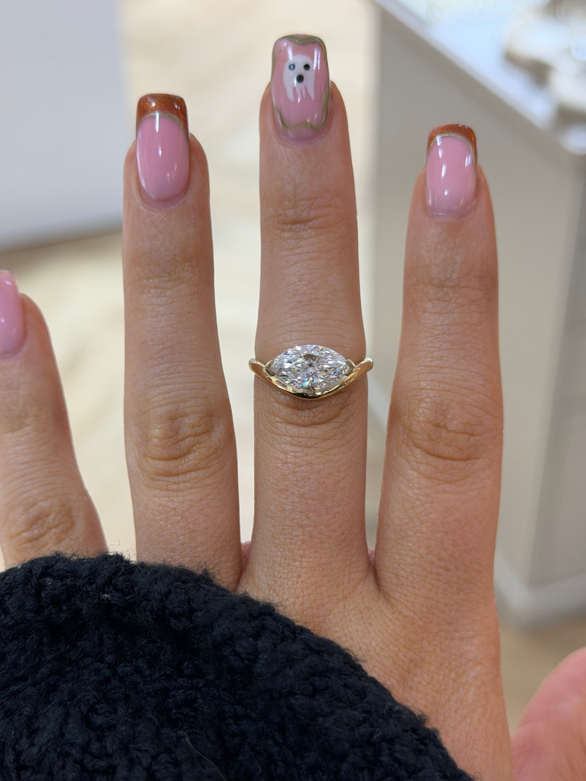 The Solstice east-west marquise lab diamond engagement ring, worn on the hand