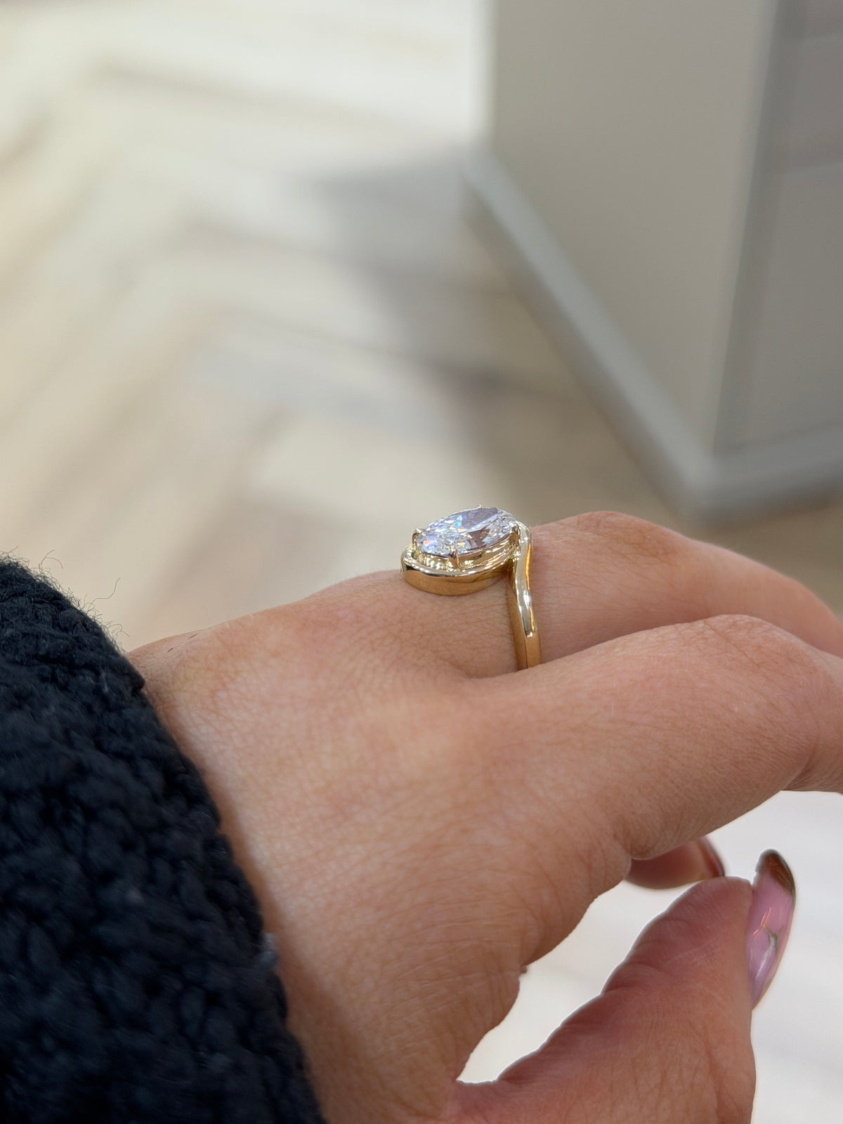 The Embrace 2ct oval lab diamond bypass ring in 9k yellow gold, side view on the hand