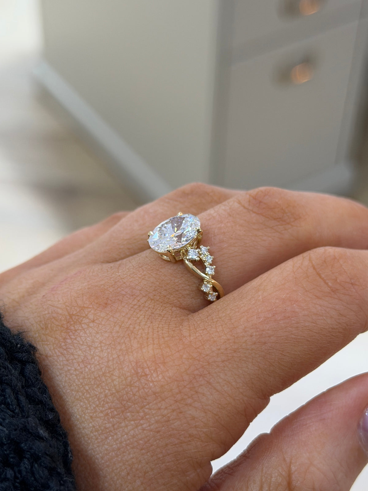The Entwine 2.5ct oval lab diamond ring in 9k yellow gold, side view on the hand