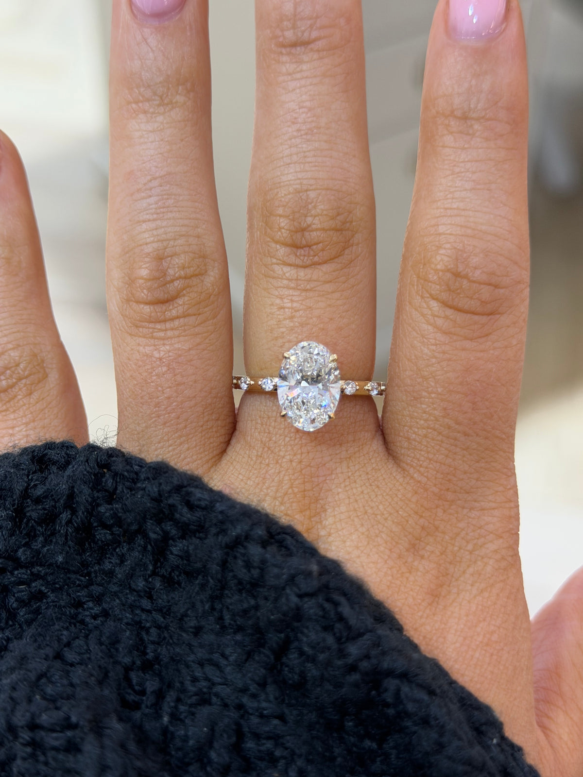 The Lumière 3ct oval lab diamond engagement ring, worn on the hand