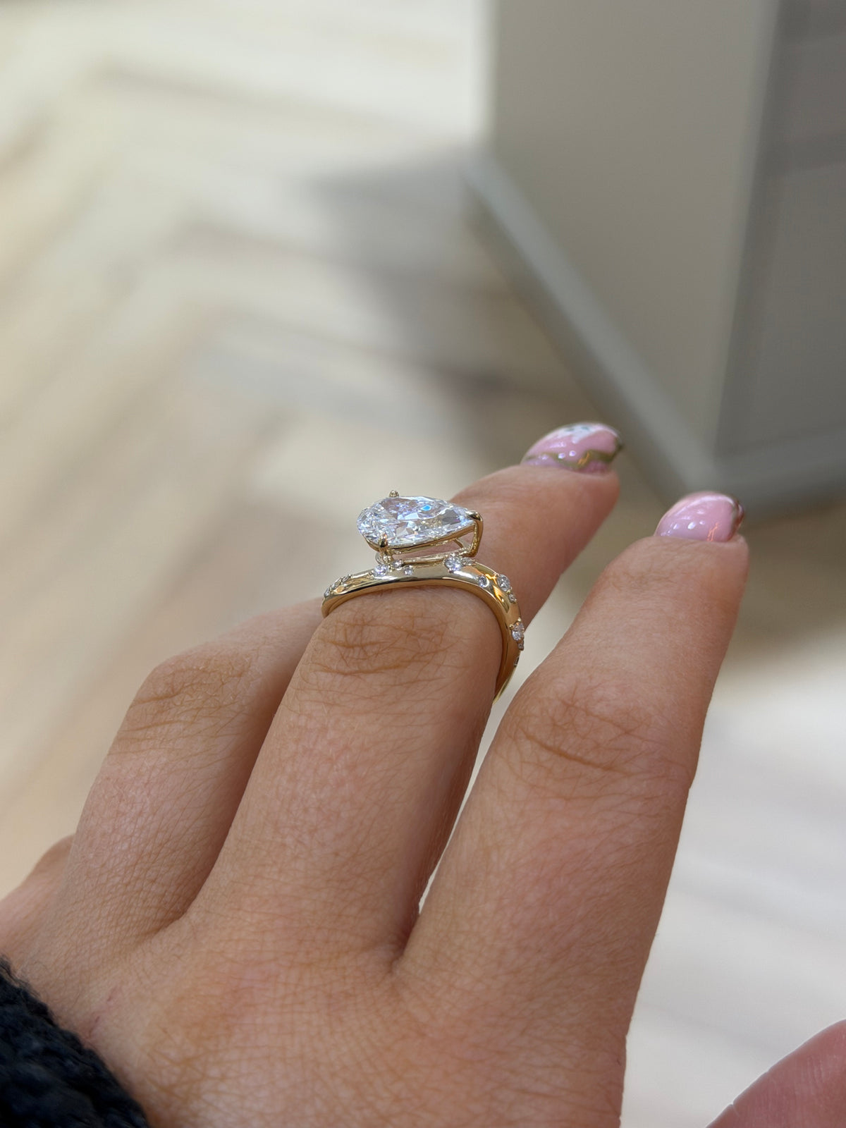 The Orbit 2ct pear lab diamond ring in 9k yellow gold, side view on the hand