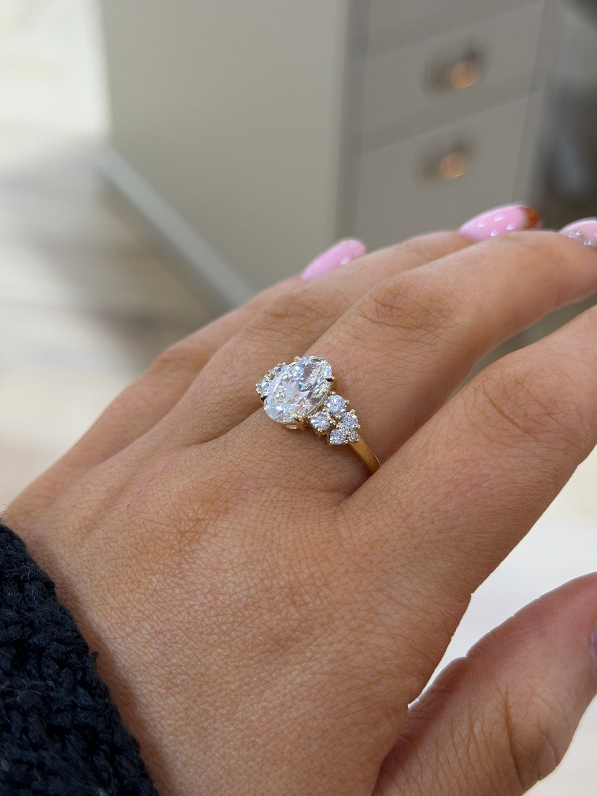 The Primrose 2.5ct oval lab diamond cluster ring in 9k yellow gold, side view on the hand