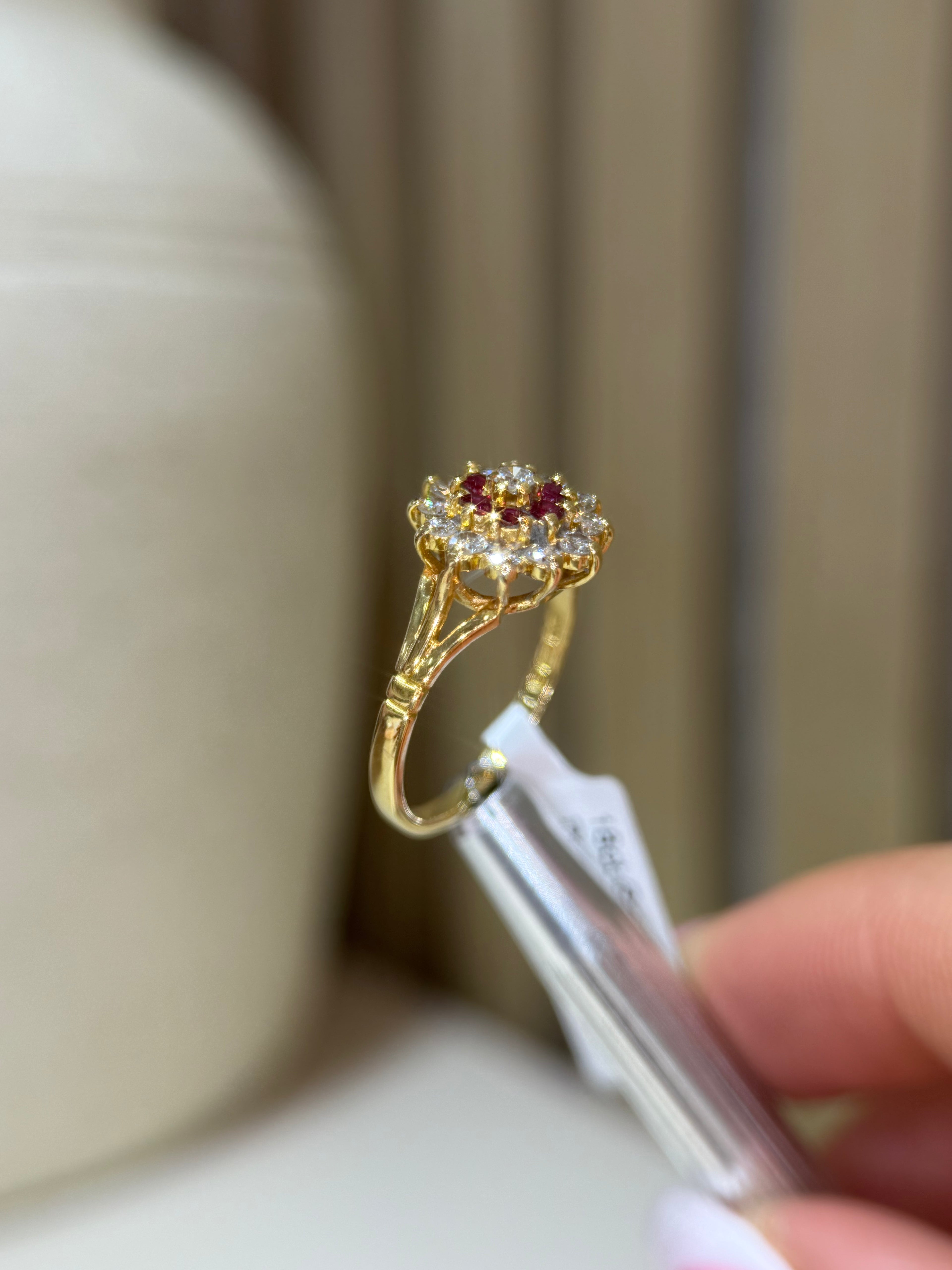 Ruby, diamond and gold cluster ring, showing close up of detail from the side.