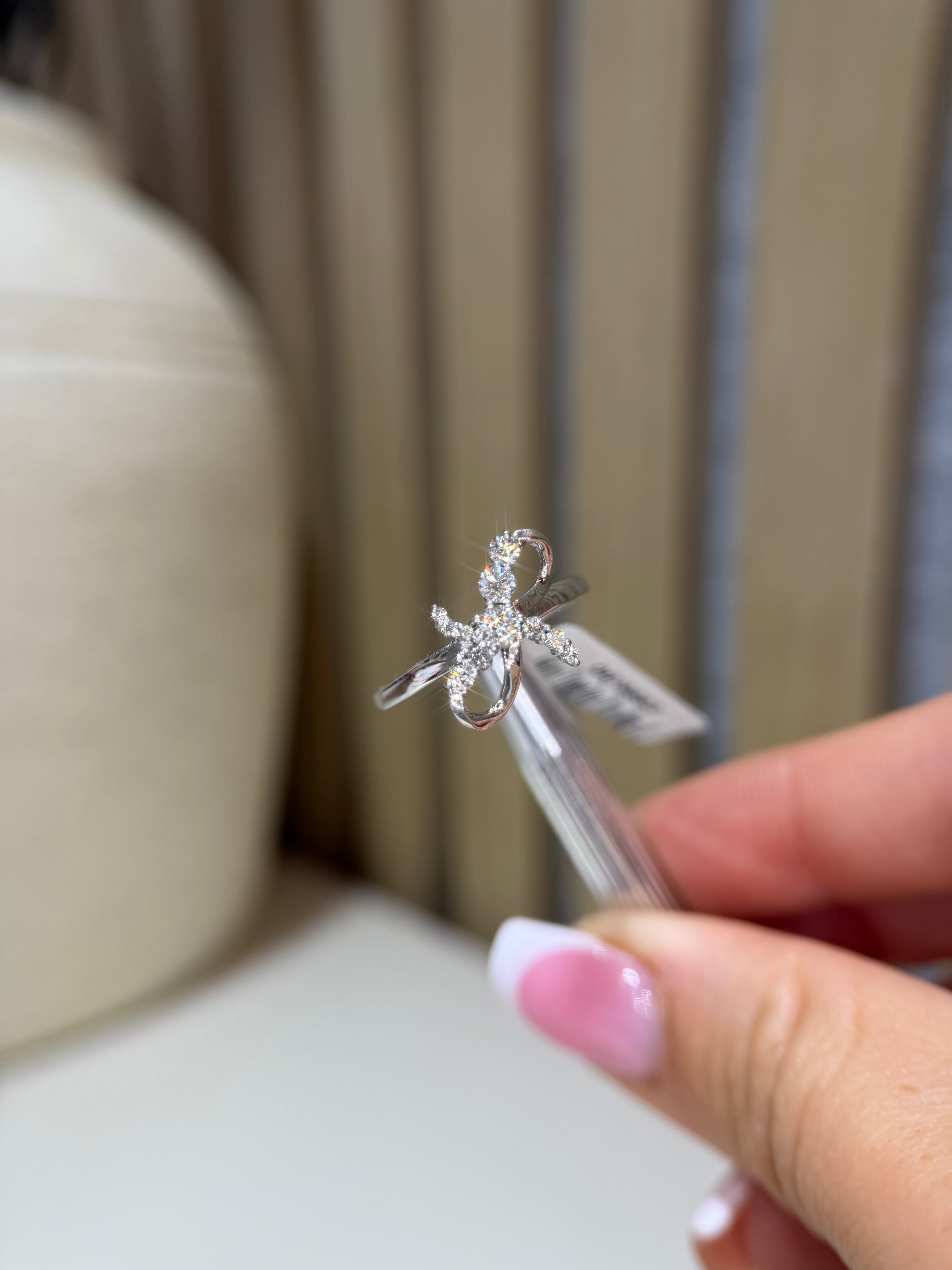 Bow infinity diamond ring on hand